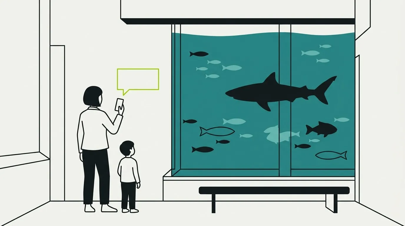 A visitor and child at an aquarium viewing window, asking a question on a phone